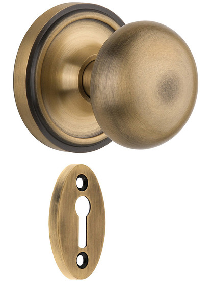 Classic Rosette Mortise Lock Set with Round Brass Knobs in Antique Brass.